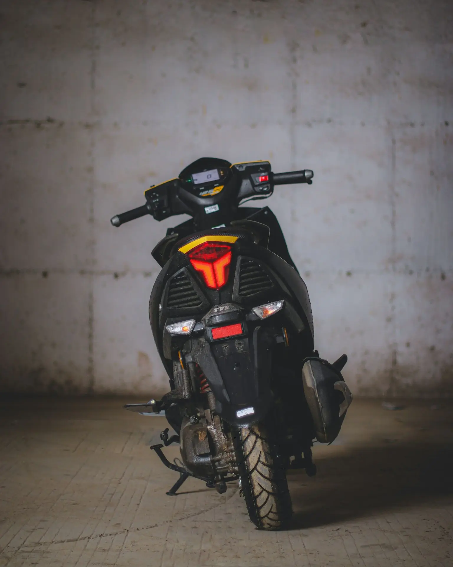 black motorcycle parked on brown floor